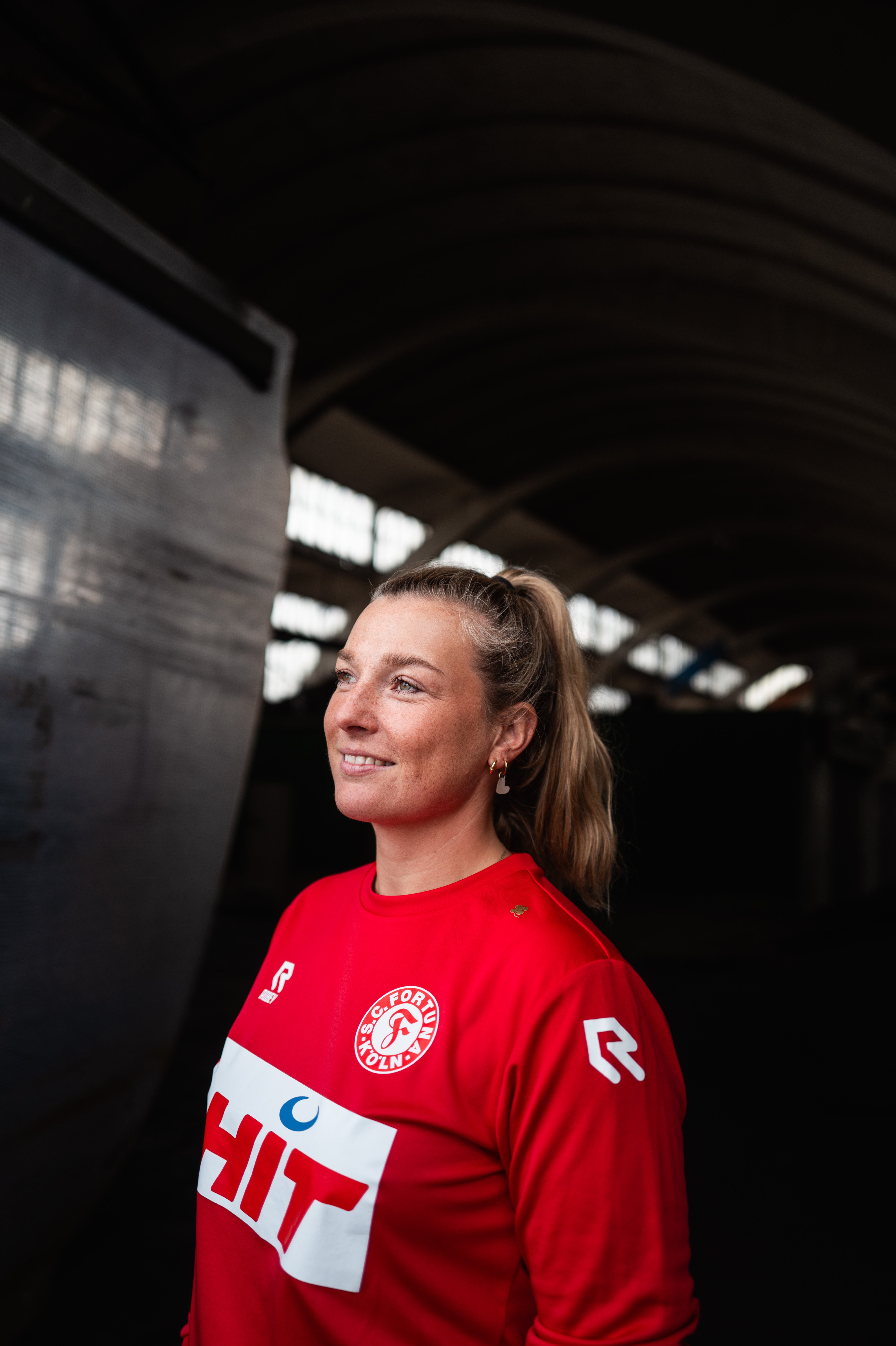 Eine Dame trägt das langarm-Traininshirt von Fortuna Köln.